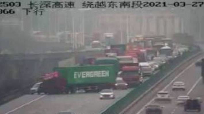 truck carrying Evergreen container across freeway