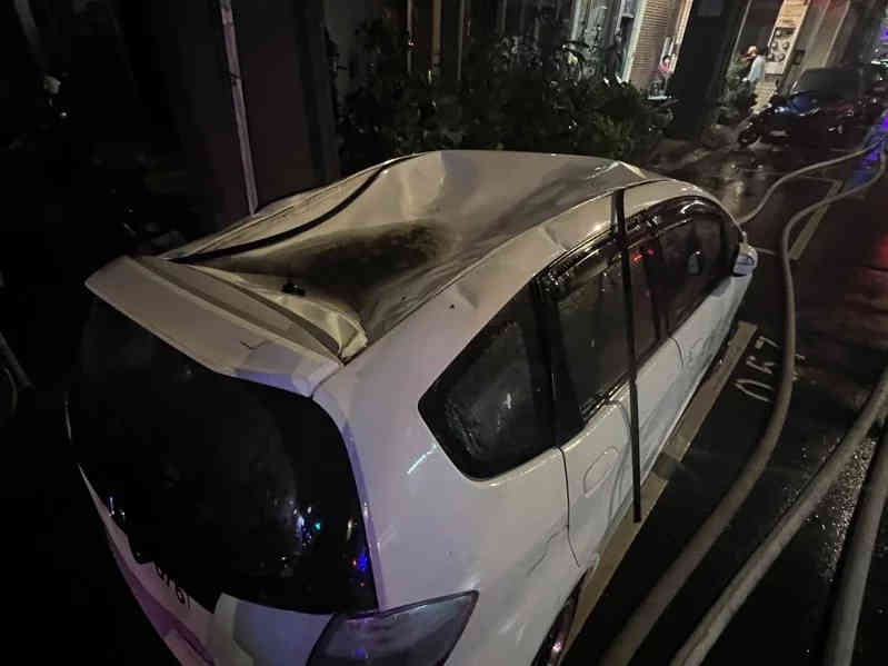 Car with dented roof after man fell from 6th floor apartment